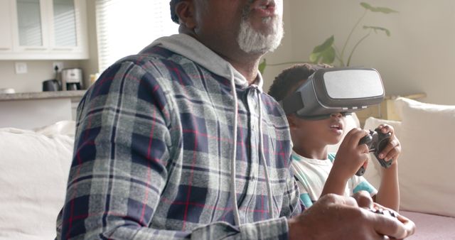 Grandfather and Grandson Gaming with VR Headsets and Controllers on Sofa - Download Free Stock Images Pikwizard.com