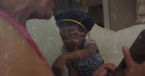 Grandmother and granddaughter connecting on tablet with global map overlay for learning
