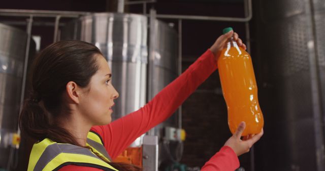 Female Quality Inspector Examining Beverage Bottle in Factory - Download Free Stock Images Pikwizard.com