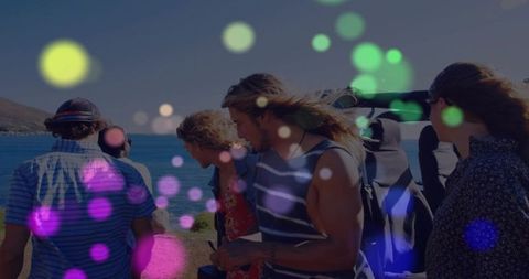 Young friends exploring sunlit coastal cliffs with backpacks and colorful bokeh lights