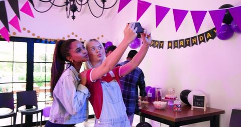 Friends Taking Selfie Enjoying a Lively Birthday Celebration