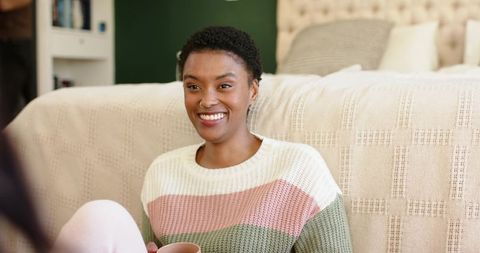 Woman Relaxing with Hot Drink in Cozy Bedroom Setting