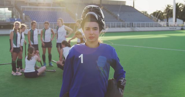 Field Hockey Goalkeeper Posing with Teammates in Background During Practice - Download Free Stock Images Pikwizard.com