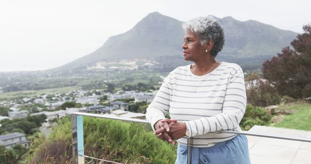 Senior Woman Relaxing on Balcony with Scenic Mountain View - Download Free Stock Images Pikwizard.com