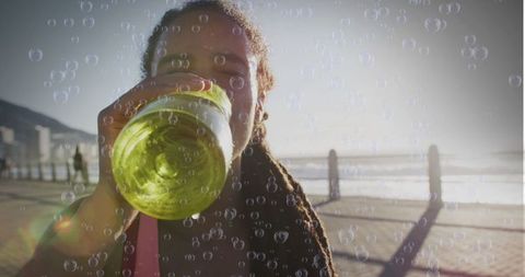Biracial Woman Hydrating on Sunny Streamlined Promenade