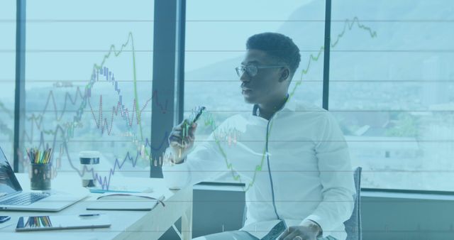 Businessman Analyzing Financial Graphs in Modern Office - Download Free Stock Images Pikwizard.com