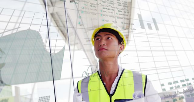 Image of digital interface showing graph with changing values over male engineer wearing safety helmet looking at a building. Global digital network concept digitally generated image.