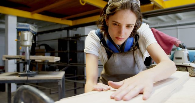 Focused Female Carpenter Working with Wood in Workshop - Download Free Stock Images Pikwizard.com