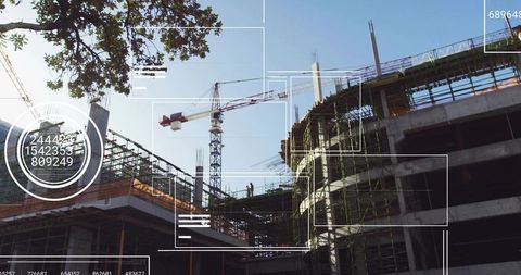 Modern urban construction site with crane and workers