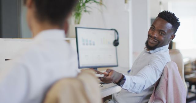 Young Professional Man Smiling and Handing Document at Desk - Download Free Stock Images Pikwizard.com