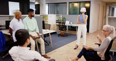 Team Meeting with VR Presentation in Modern Office Setting