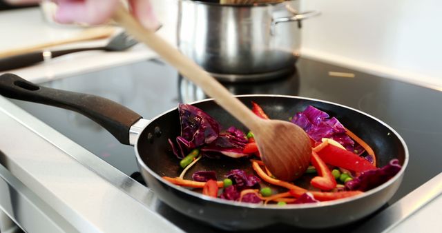 Healthy Vegetable Stir Fry Cooking on Stove with Wooden Spoon in Kitchen - Download Free Stock Images Pikwizard.com