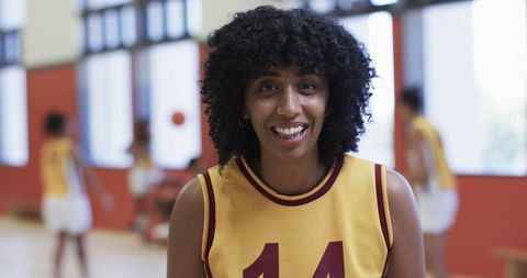 Basketball athlete smiling on indoor court