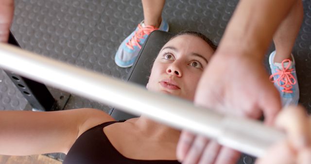 Young Woman Lifting Weights at Gym with Trainer Spotting Close-Up - Download Free Stock Images Pikwizard.com