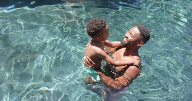 Father and Son Bonding in Swimming Pool on Sunny Day - Download Free Stock Images Pikwizard.com