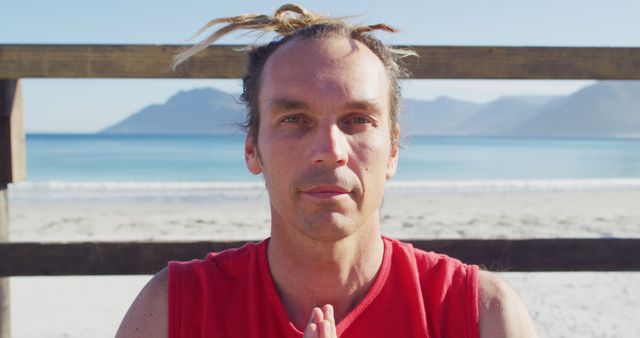 Man Practicing Yoga at Serene Beach with Mountains in Background - Download Free Stock Images Pikwizard.com