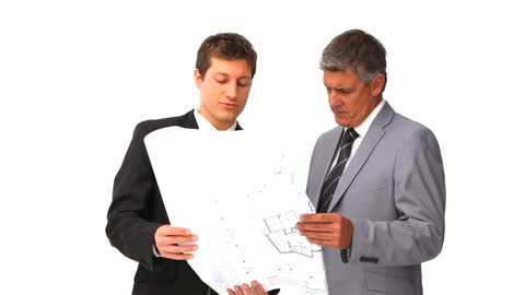 Architects Collaborating over Building Plans in professional attire