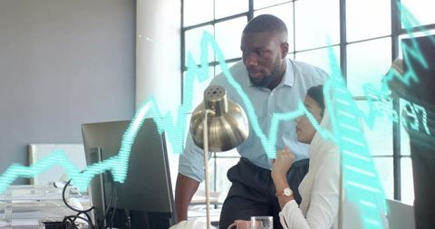 Professionals Analyzing Data with Graph on Monitor