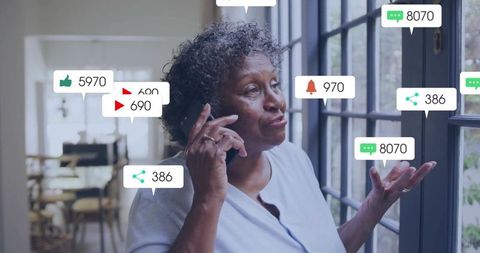 Senior woman handling smartphone notifications at home with social media alert overlays