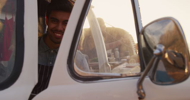 Smiling Young Man Sitting in Vintage Truck Window Frame - Download Free Stock Images Pikwizard.com