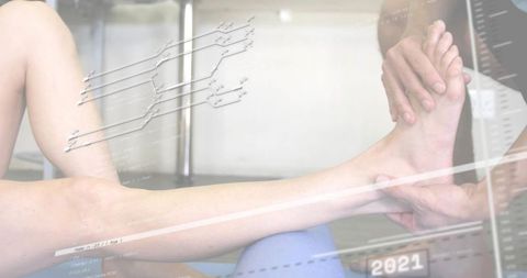 Physiotherapist supporting patient ankle during mobility rehab manual therapy digital overlay 2021