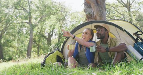 Diverse Couple Enjoying Camping and Tea in Sunny Park