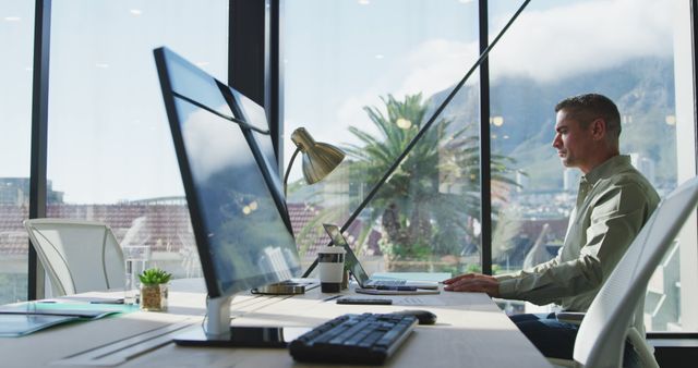 Young Professional Working at Modern Office Desk with Mountain View - Download Free Stock Images Pikwizard.com