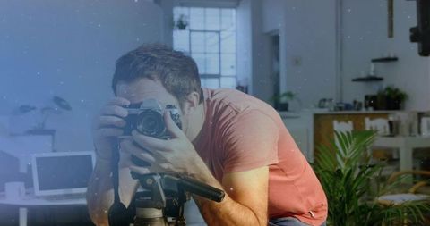 Dedicated Photographer Adjusting Camera in Modern Workspace