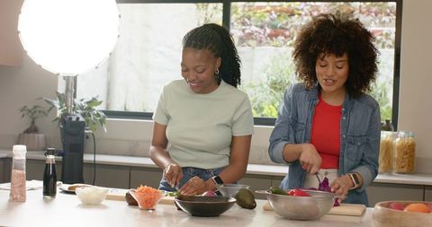 Diverse Friends Chopping Vegetables at Bright Kitchen Island, Healthy Cooking
