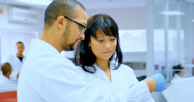 Scientists Collaborating in Laboratory Checking Sample - Download Free Stock Images Pikwizard.com