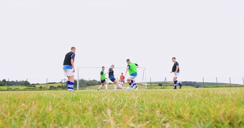 Soccer Team in Action on Grassy Training Field