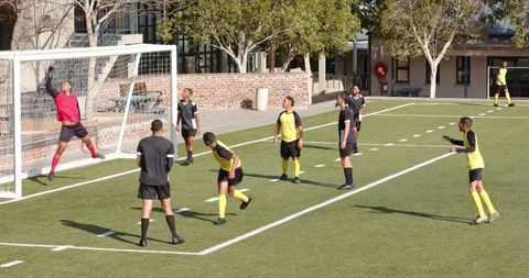 Youth soccer players improving skills on field with team practice