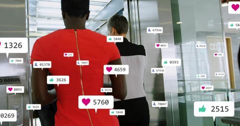 Businesswomen walking to elevator with floating social media notifications and analytics