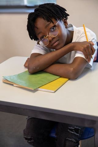 Thoughtful African American Teen Student at School Desk