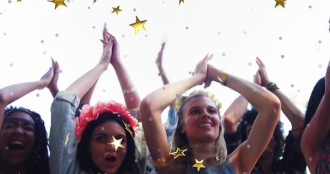 Festival Attendees Cheerfully Celebrating with Raised Arms