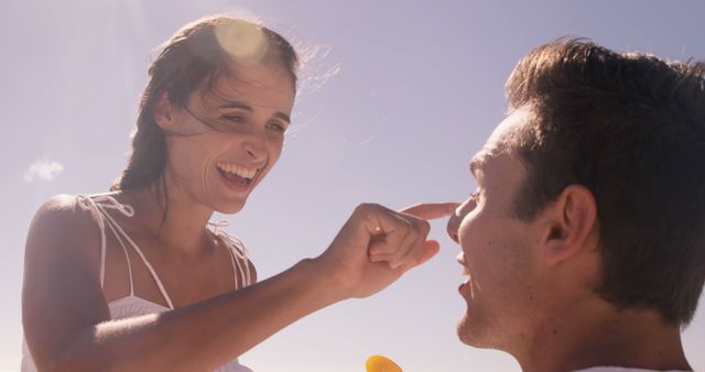 Happy Couple Applying Sunscreen on Beach - Download Free Stock Images Pikwizard.com