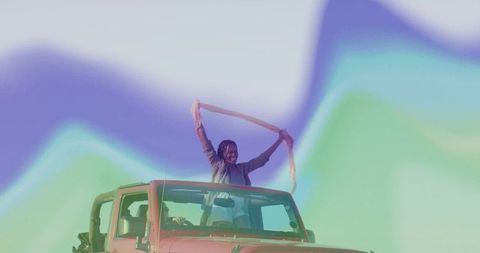 Woman Enjoying Freedom in Red Jeep with Scarf and Pastel Landscape