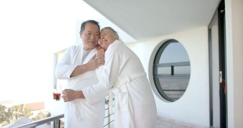 Senior couple enjoying relaxed morning on modern balcony