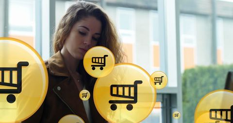 Woman shopping online with digital shopping cart icons