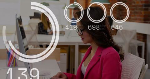 Businesswoman Analyzing Data on Computer with Futuristic Overlay