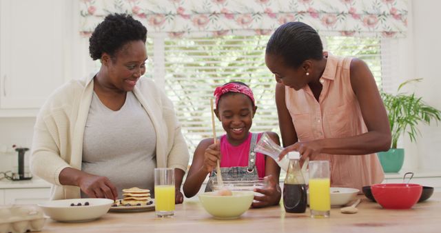 African american grandmother, mother and daughter preparing dinner in the kitchen at home. family, togetherness and happiness concept