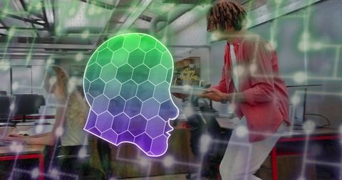 Leaning teammate sharing tablet with colleague in open office with neon honeycomb AI overlay