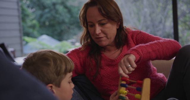 Mother Engaging with Child Using Educational Toy in Cozy Home - Download Free Stock Images Pikwizard.com