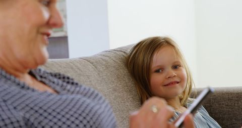 Grandmother Enjoying Technology Fun with Young Granddaughter