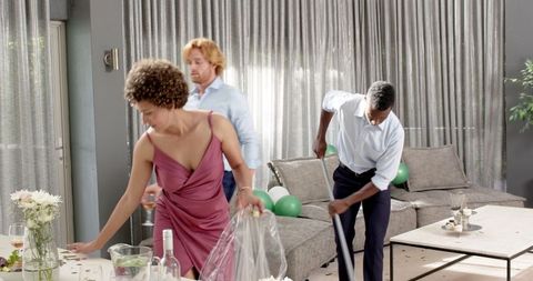 Friends Tidying Up Living Room After Wedding Party