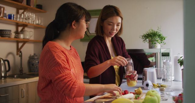 Two Women Preparing Fresh Juice in Cozy Kitchen - Download Free Stock Images Pikwizard.com