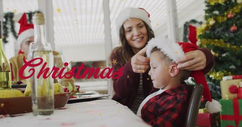 Mother and Son Celebrating Christmas with Santa Hats - Download Free Stock Images Pikwizard.com