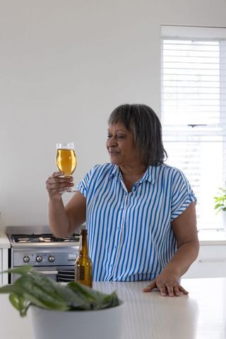 Senior African American Woman Enjoying Drink Examination Venture