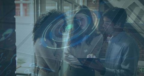 Team collaborating over tablet with futuristic HUD overlay in modern glass office workspace