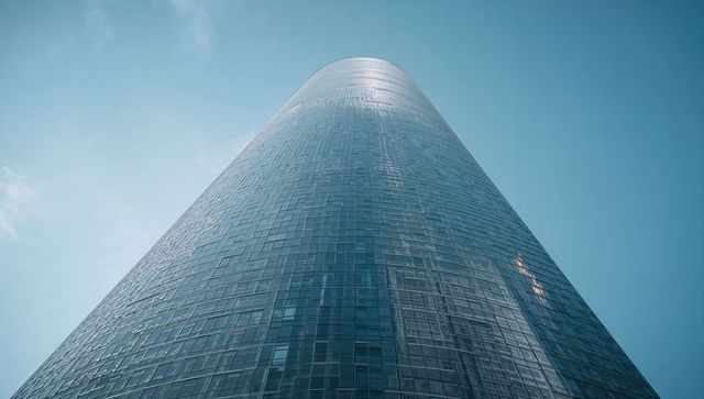 Rising Cylindrical Glass Skyscraper Reflecting Sunlight, Modern Urban Curtainwall Facade